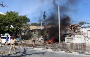 Somali policemen secure the scene of an explosion near Waberi police station station in Mogadishu