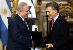 Argentina’s President Macri gives Israeli Prime Minister Netanyahu a box with hard drives containing all of Argentina’s government archives related to the Holocaust during a ceremony at the Casa Rosada Presidential Palace in Buenos Aires