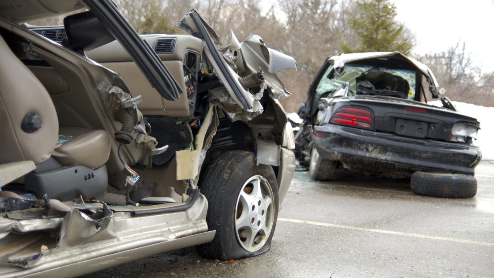 Remaining debris of cars involved in a car crash on road