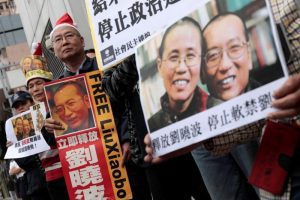 Pro-democracy demonstrators hold up photo of jailed Chinese Nobel Peace Prize laureate Liu Xiaobo during a protest to urge for the release of Liu, outside the Chinese liaison office in Hong Kong