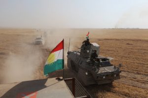 A Kurdish flag is seen on military vehicles of the Kurdish Peshmerga forces on the southeast of Mosul