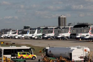 Passenger jets stand on the runway of London City Airport, in London