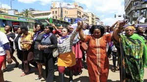 Women take part in a protest along a main street in the Kenyan capital of Nairobi