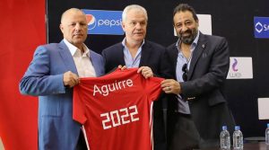 Javier Aguirre, the newly named coach for Egypt national soccer team, holds a jersey reading 2022 with Egyptian FA head Hany Abo Rida and member of Egypt FA, Magdy Abdelghany in Cairo