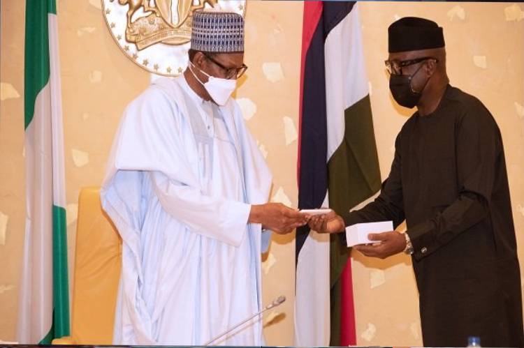 President Buhari receives first made in Nigeria mobile phone at FEC, swears in two federal commissioners